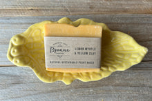 Bar of soap with a Byanne recycled paper label on a leaf-shaped yellow soap dish.
