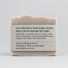 A rectangular bar of soap with a gray paper label wrapped around it,the label reads 'GENTLE ON THE SKIN AND THE PLANET' and includes ingredients and the website byanne.